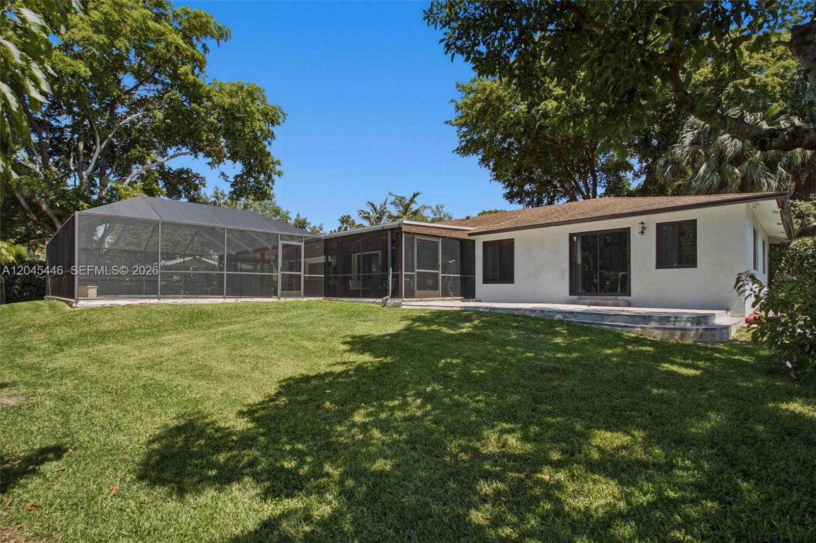 8440 Southwest 180th Street Palmetto Bay, FL 33157 - Photo 52 of 54 a view of a house with a backyard