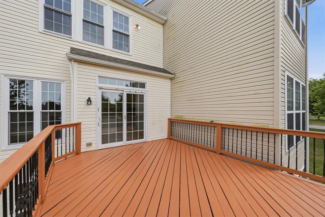 8761 Cascade Road Breinigsville, PA 18031 - Photo 71 of 84 A spacious wooden deck extends from the residence, perfect for outdoor relaxation.