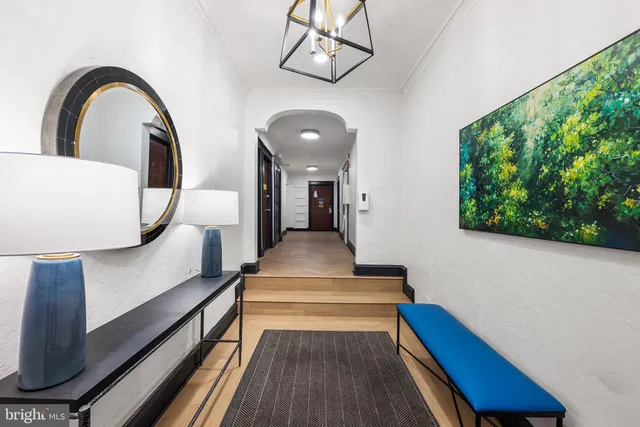 a view of entryway and hall with wooden floor