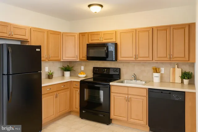 a kitchen with a sink stove and refrigerator