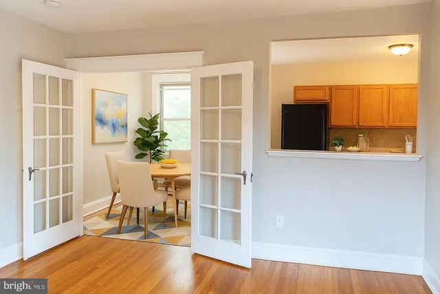 a dining room with furniture and wooden floor