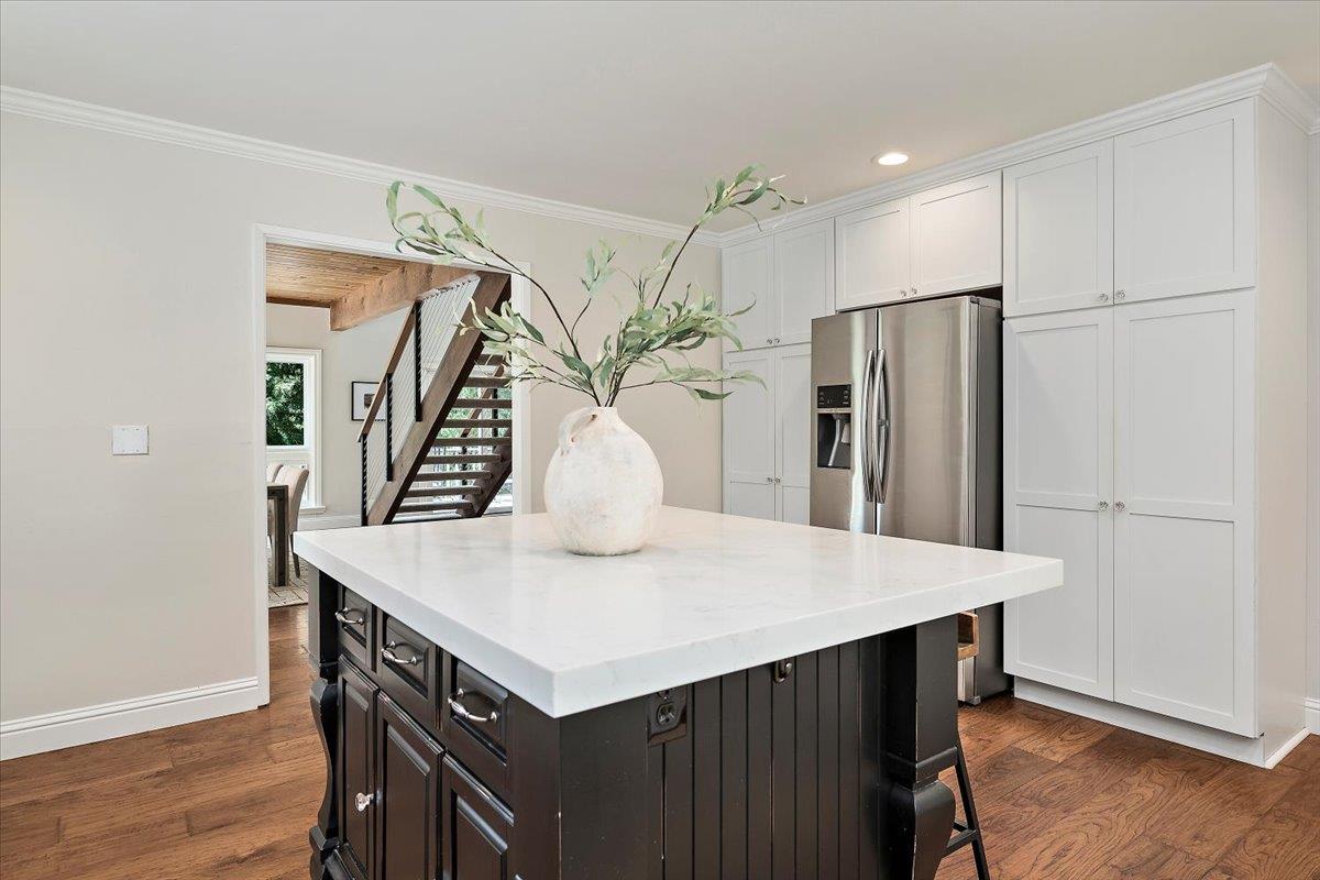 15251 Old Ranch Road Los Gatos, CA 95033 - Photo 11 of 38 a kitchen with stainless steel appliances a table chairs and wooden floor