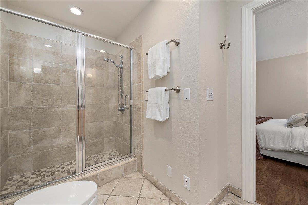 15251 Old Ranch Road Los Gatos, CA 95033 - Photo 18 of 38 a bathroom with a shower and toilet