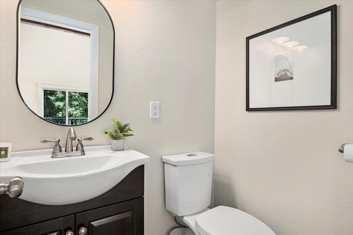 15251 Old Ranch Road Los Gatos, CA 95033 - Photo 19 of 38 a bathroom with a toilet a sink and a mirror