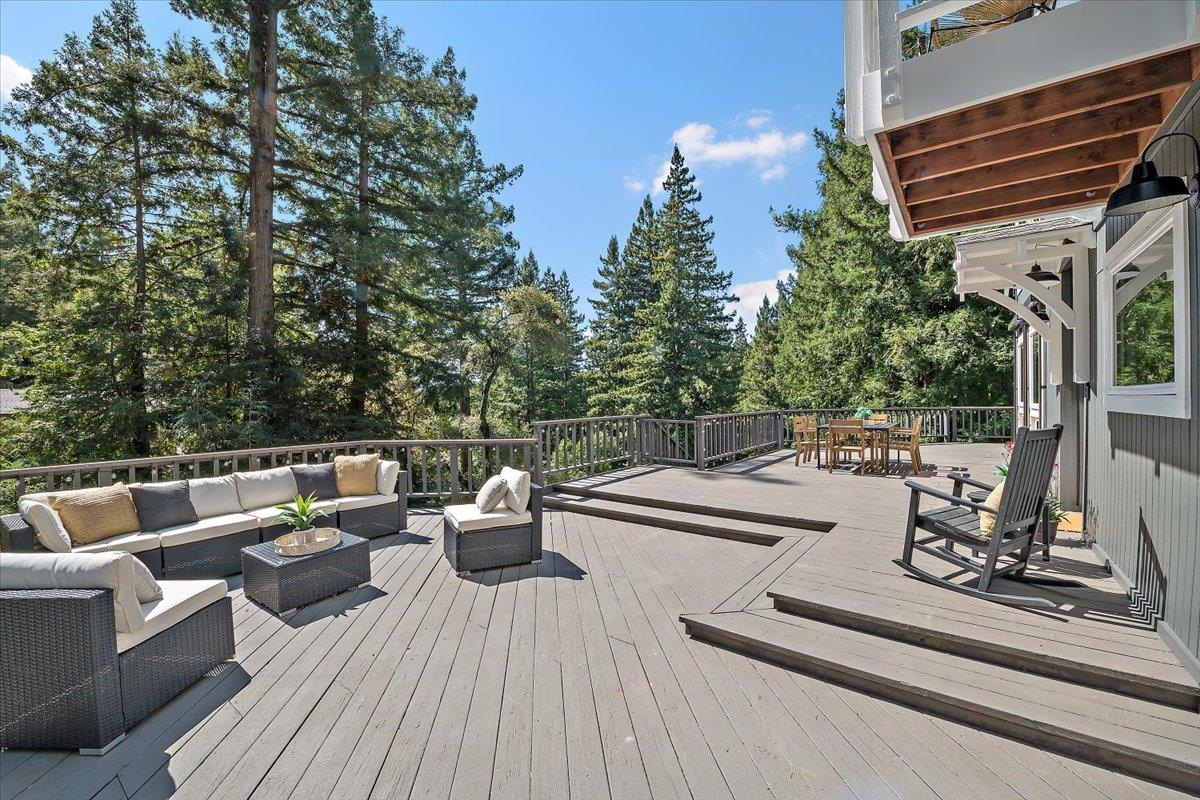 15251 Old Ranch Road Los Gatos, CA 95033 - Photo 2 of 38 a view of a deck with couches wooden floor and fence