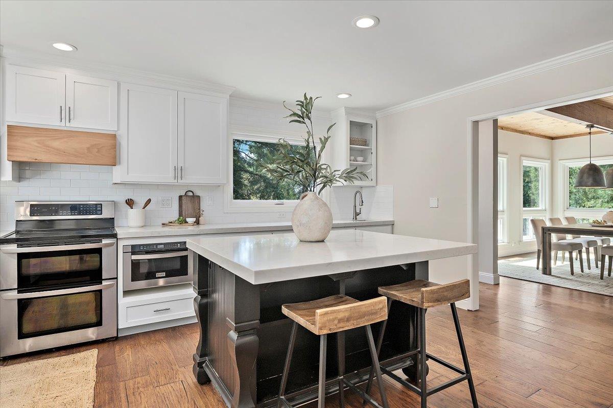 15251 Old Ranch Road Los Gatos, CA 95033 - Photo 8 of 38 a kitchen with stainless steel appliances kitchen island a table and chairs in it