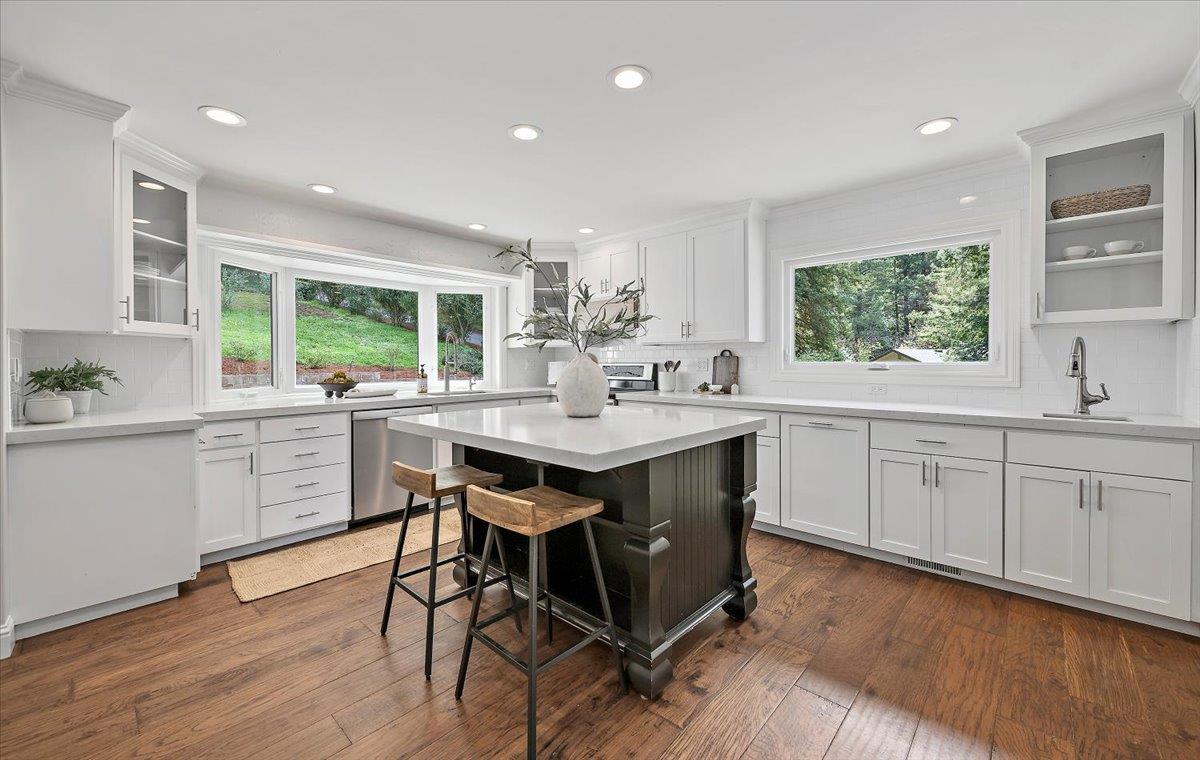 15251 Old Ranch Road Los Gatos, CA 95033 - Photo 9 of 38 a kitchen with a table chairs sink and cabinets
