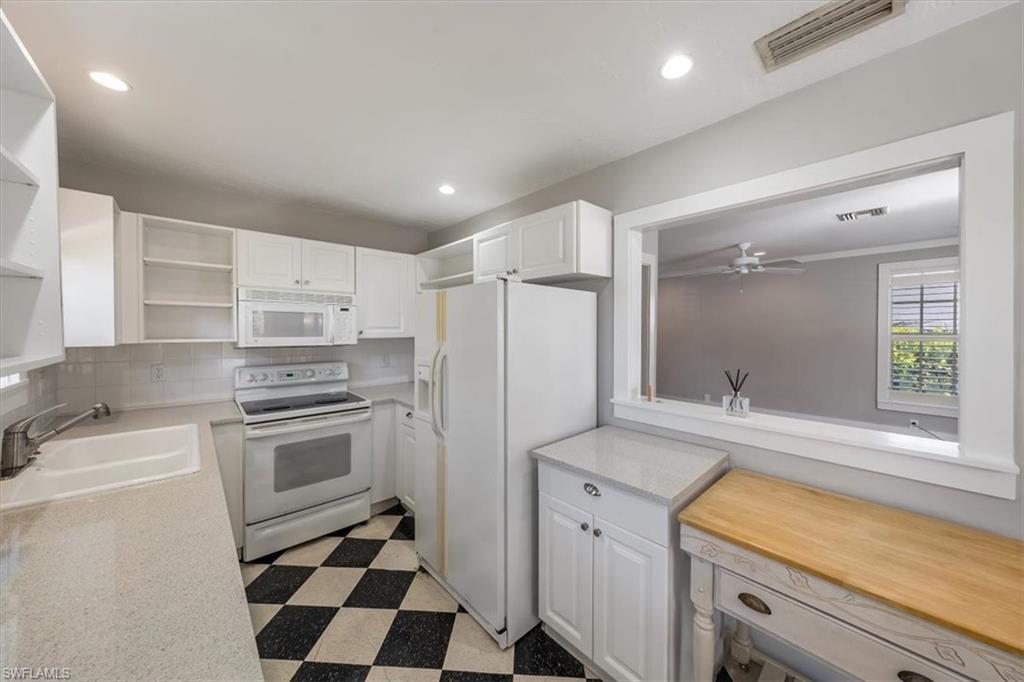 1984 Frederick Street Naples, FL 34112 - Photo 11 of 25 a kitchen with a stove a sink and a refrigerator