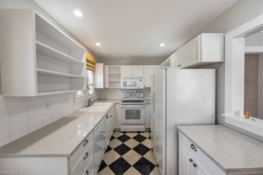 1984 Frederick Street Naples, FL 34112 - Photo 12 of 25 a kitchen with a sink stove and refrigerator