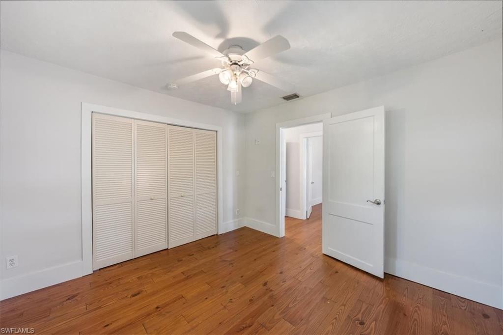1984 Frederick Street Naples, FL 34112 - Photo 18 of 25 a view of an empty room with wooden floor
