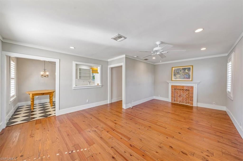 1984 Frederick Street Naples, FL 34112 - Photo 5 of 25 a view of an empty room with wooden floor and a window