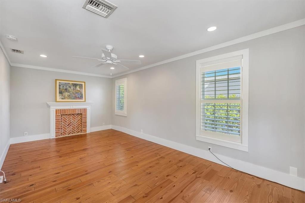 1984 Frederick Street Naples, FL 34112 - Photo 6 of 25 wooden floor in an empty room with a window