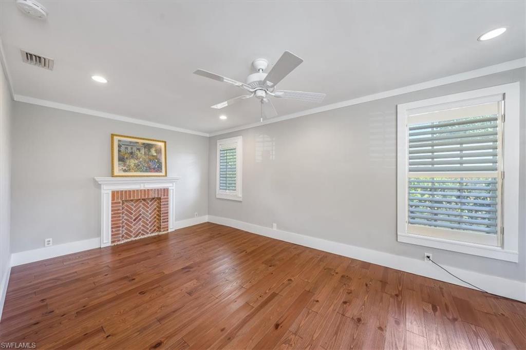 1984 Frederick Street Naples, FL 34112 - Photo 7 of 25 wooden floor in an empty room with a window