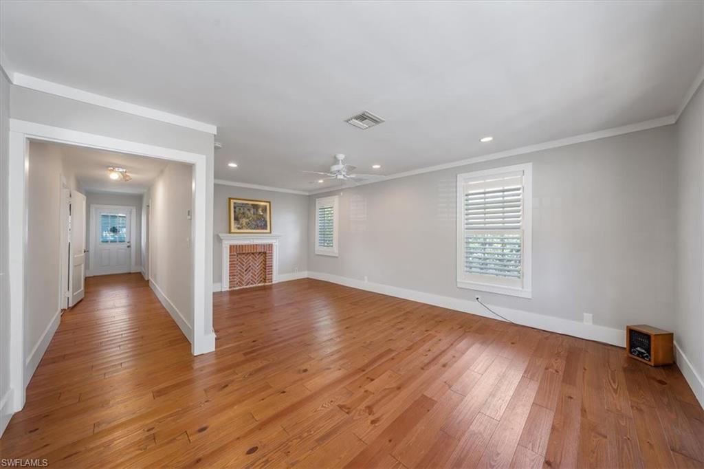 1984 Frederick Street Naples, FL 34112 - Photo 8 of 25 a view of an empty room with wooden floor and a window