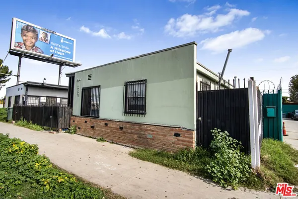 a front view of a house with plants