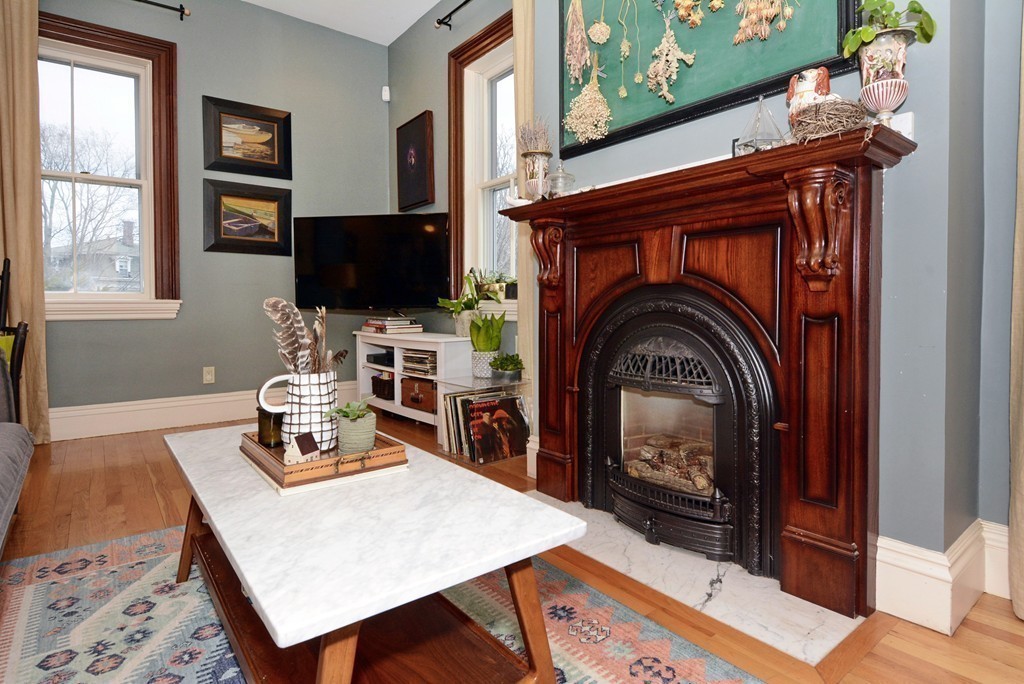 7 Winter Street, Unit 5 Salem, MA 01970 - Photo 11 of 41 a living room with furniture a flat screen tv and a fireplace