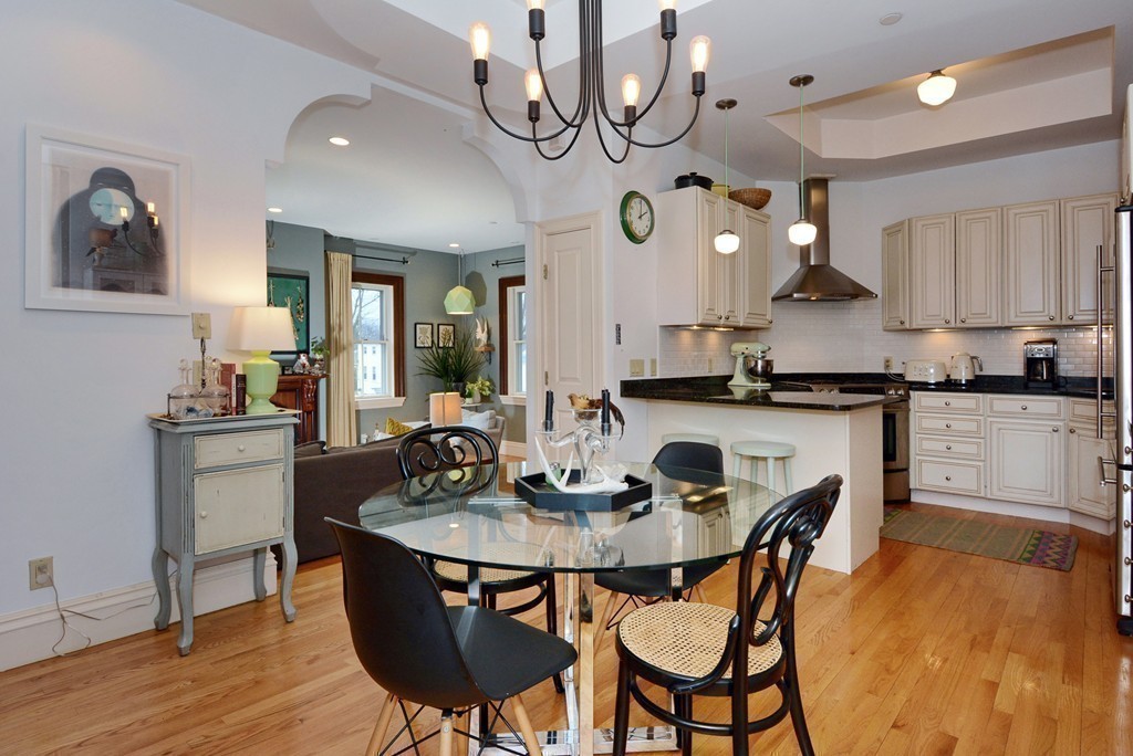 7 Winter Street, Unit 5 Salem, MA 01970 - Photo 16 of 41 a kitchen with a dining table and chairs with wooden floor