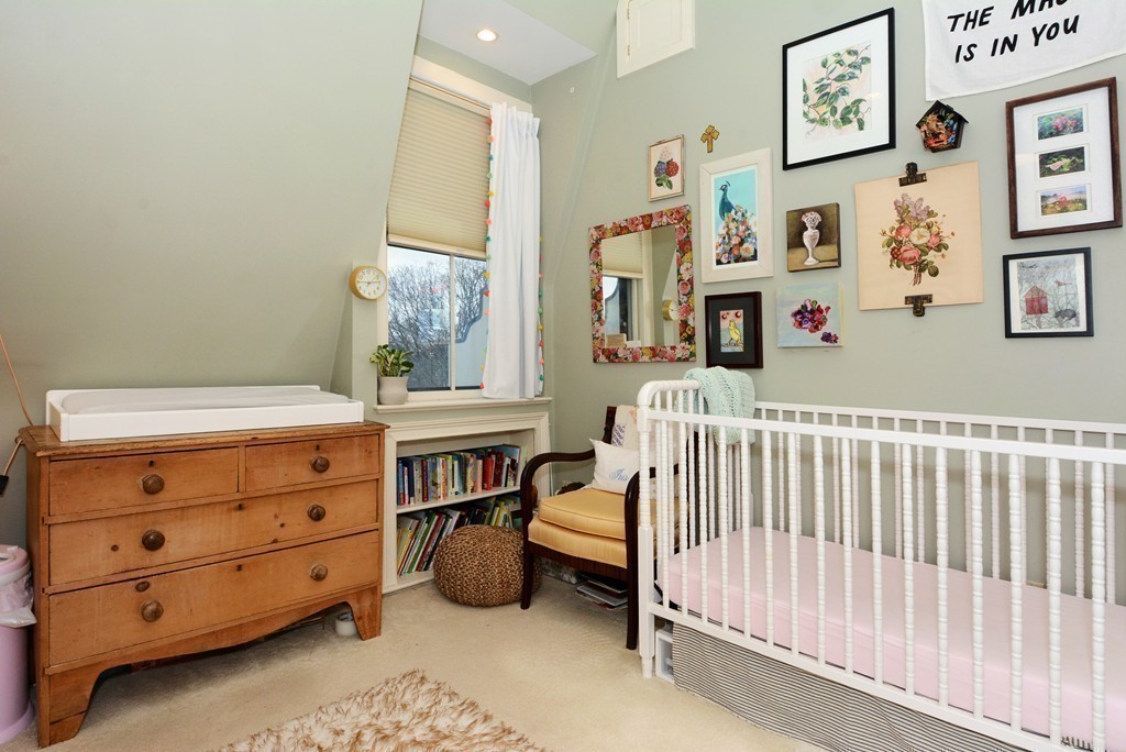 7 Winter Street, Unit 5 Salem, MA 01970 - Photo 32 of 41 a bedroom with a baby bed baby crib and the dresser