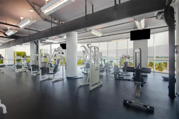a gym room with lots of gym equipment