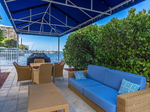 a patio with a table and chairs under an umbrella