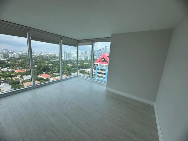 a view of room with window and wooden floor