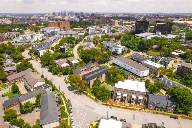 an aerial view of residential houses with outdoor space