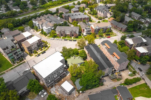 an aerial view of residential houses with outdoor space