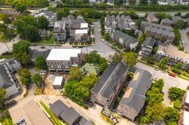 an aerial view of residential houses with outdoor space