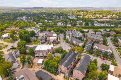 an aerial view of a residential apartment building with a yard