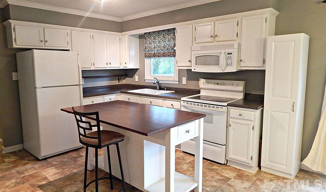 5616 Old Stage Road Raleigh, NC 27603 - Photo 4 of 15 a kitchen with stainless steel appliances a refrigerator sink and cabinets