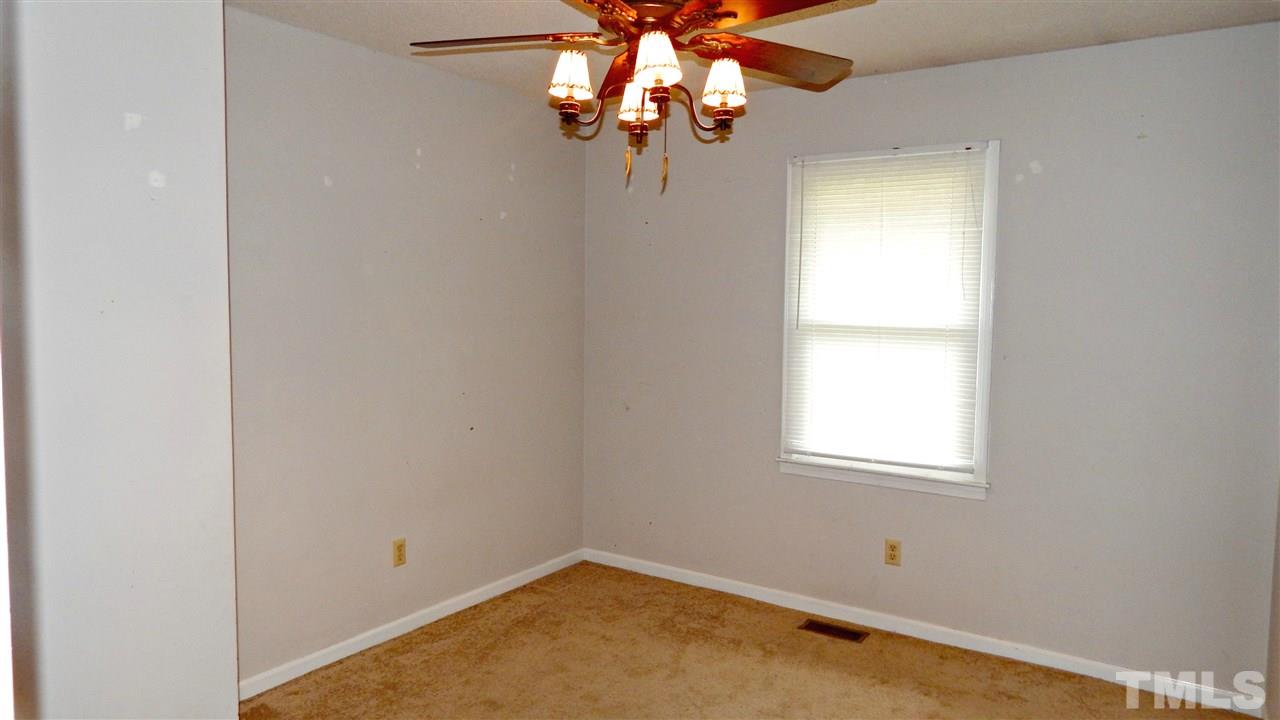 5616 Old Stage Road Raleigh, NC 27603 - Photo 8 of 15 an empty room with window and chandelier fan