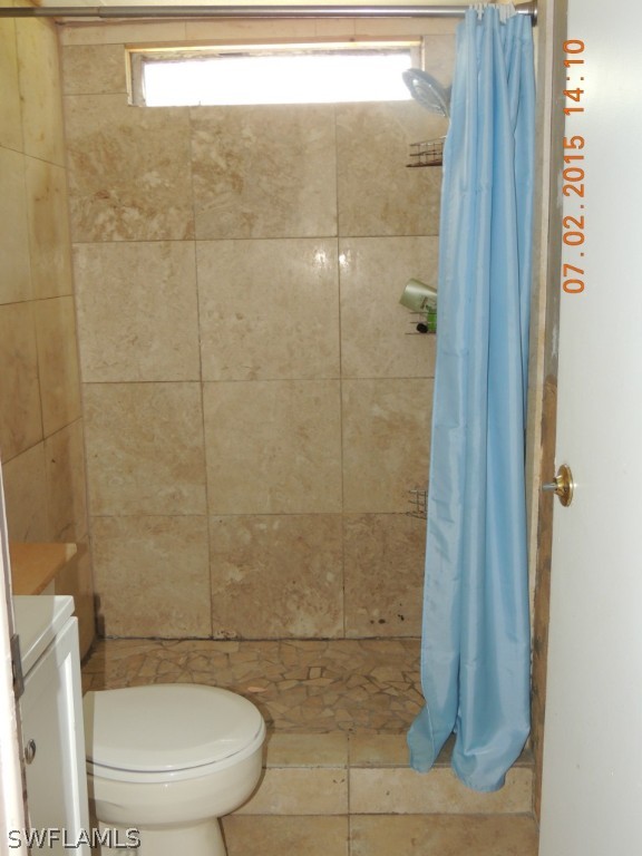 195 G Road LaBelle, FL 33935 - Photo 6 of 9 a bathroom with a shower and a toilet