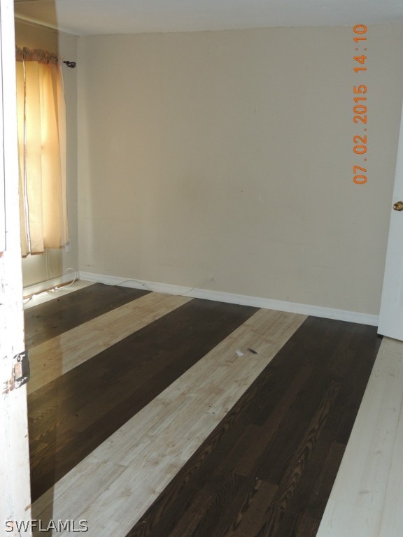 195 G Road LaBelle, FL 33935 - Photo 7 of 9 an empty room with wooden floor