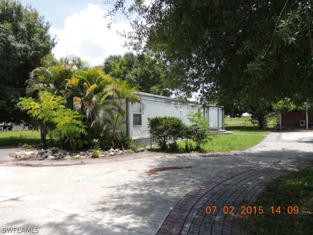 195 G Road LaBelle, FL 33935 - Photo 8 of 9 a view of a house with a yard