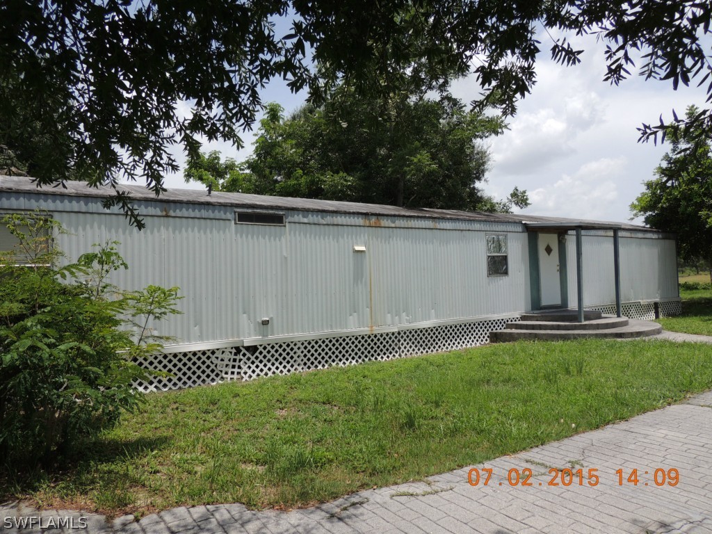 195 G Road LaBelle, FL 33935 - Photo 9 of 9 a backyard of a house with lots of green space and lake view