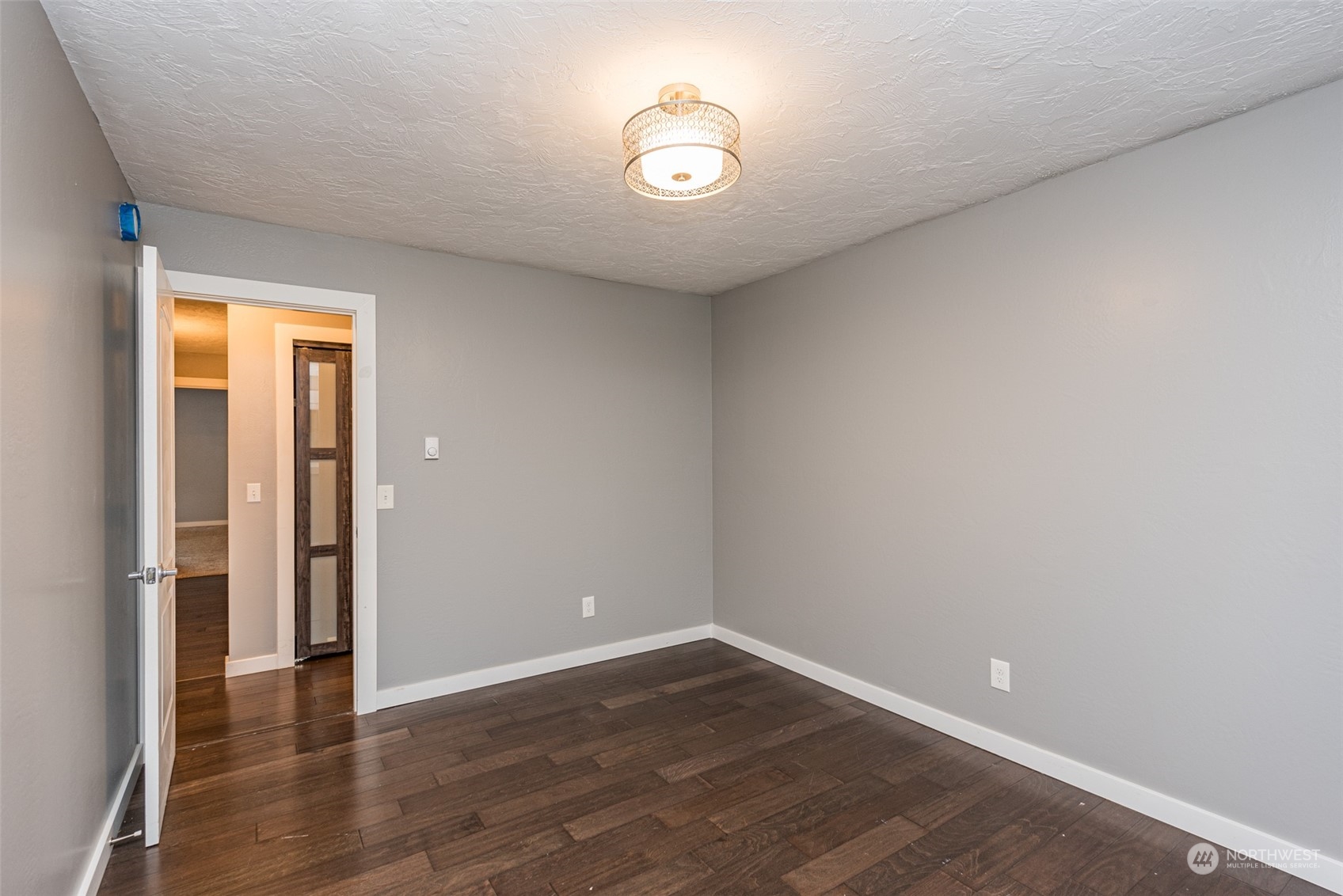 146 Sunset Place Sequim, WA 98382 - Photo 16 of 40 a view of an empty room with wooden floor and a window