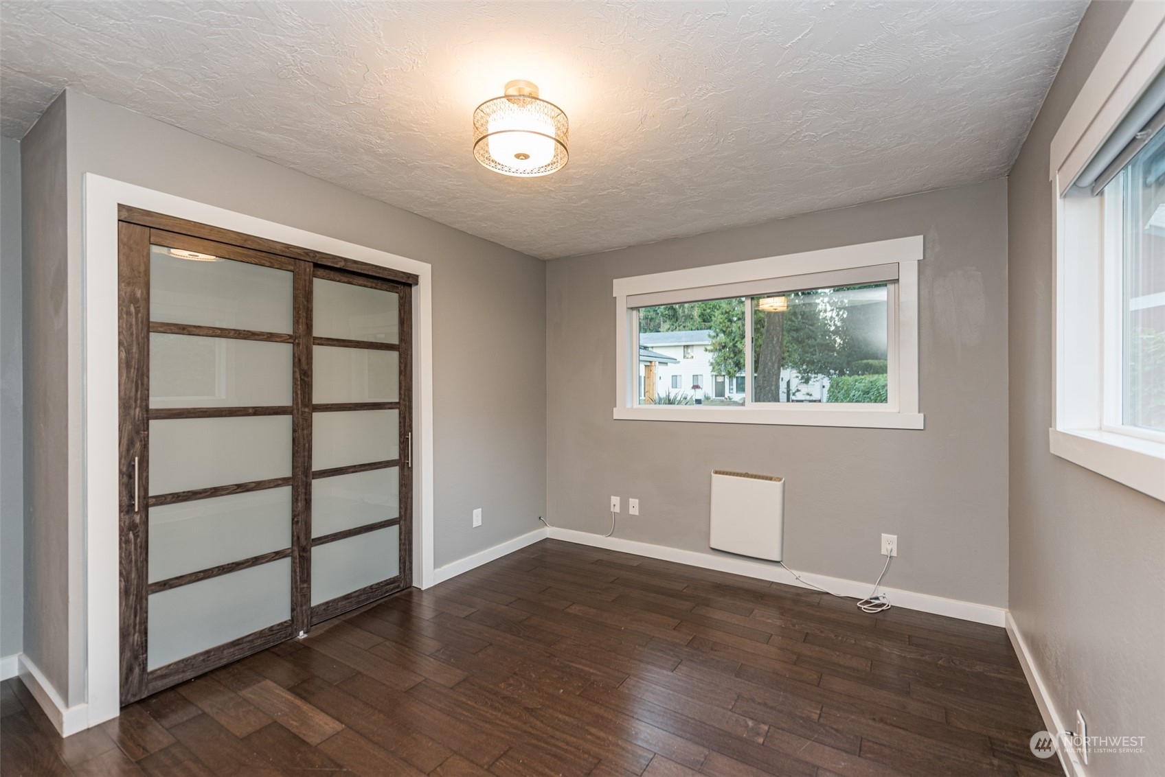 146 Sunset Place Sequim, WA 98382 - Photo 19 of 40 an empty room with wooden floor and windows