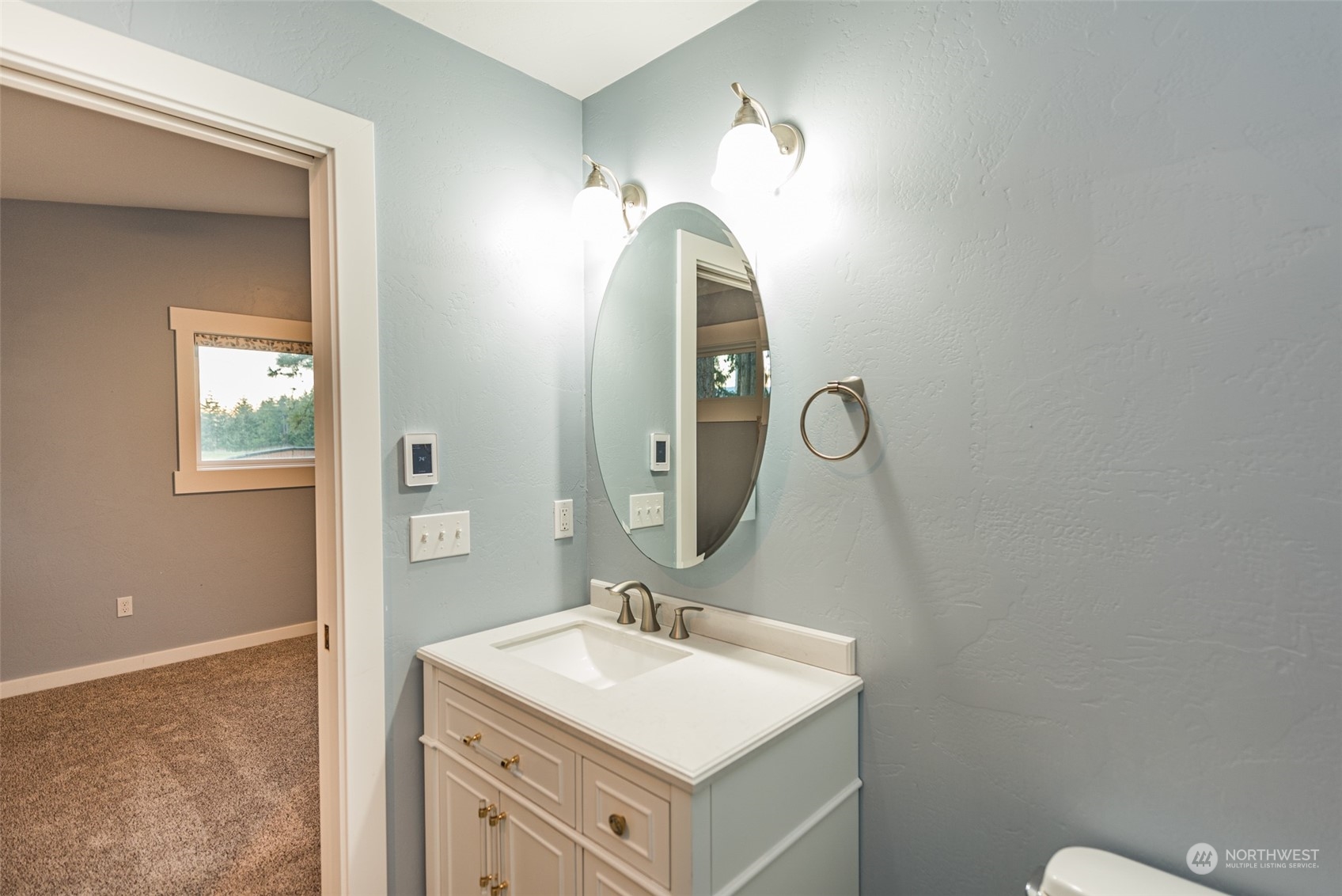 146 Sunset Place Sequim, WA 98382 - Photo 26 of 40 a bathroom with a sink vanity and mirror