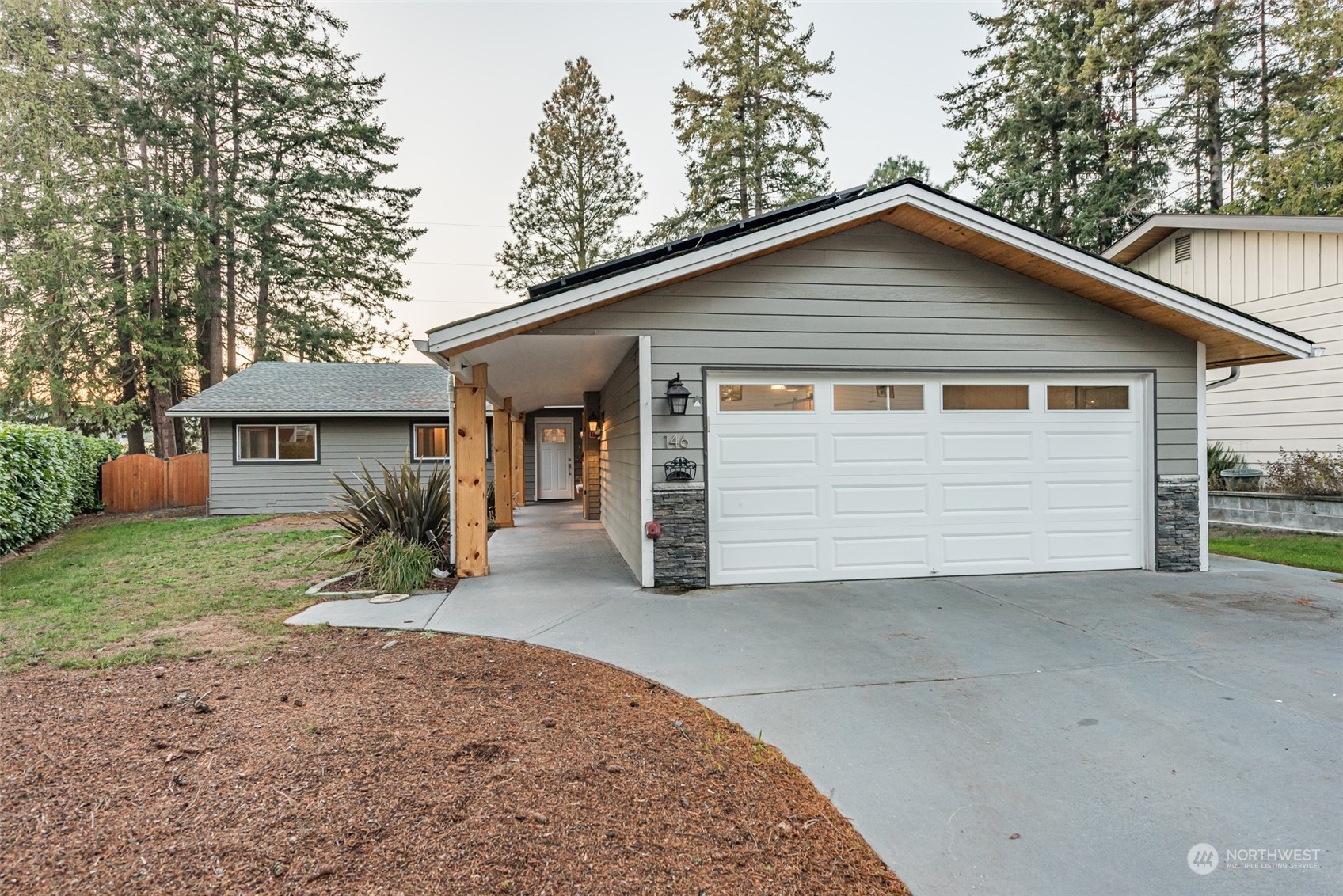 146 Sunset Place Sequim, WA 98382 - Photo 31 of 40 a front view of a house with a yard and garage