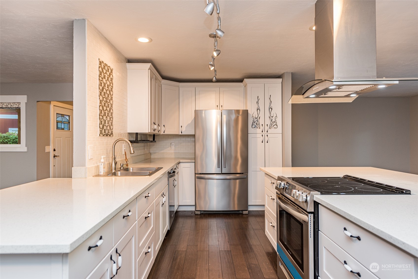 146 Sunset Place Sequim, WA 98382 - Photo 8 of 40 a kitchen with stainless steel appliances granite countertop a refrigerator a sink dishwasher a stove and a refrigerator with wooden floor