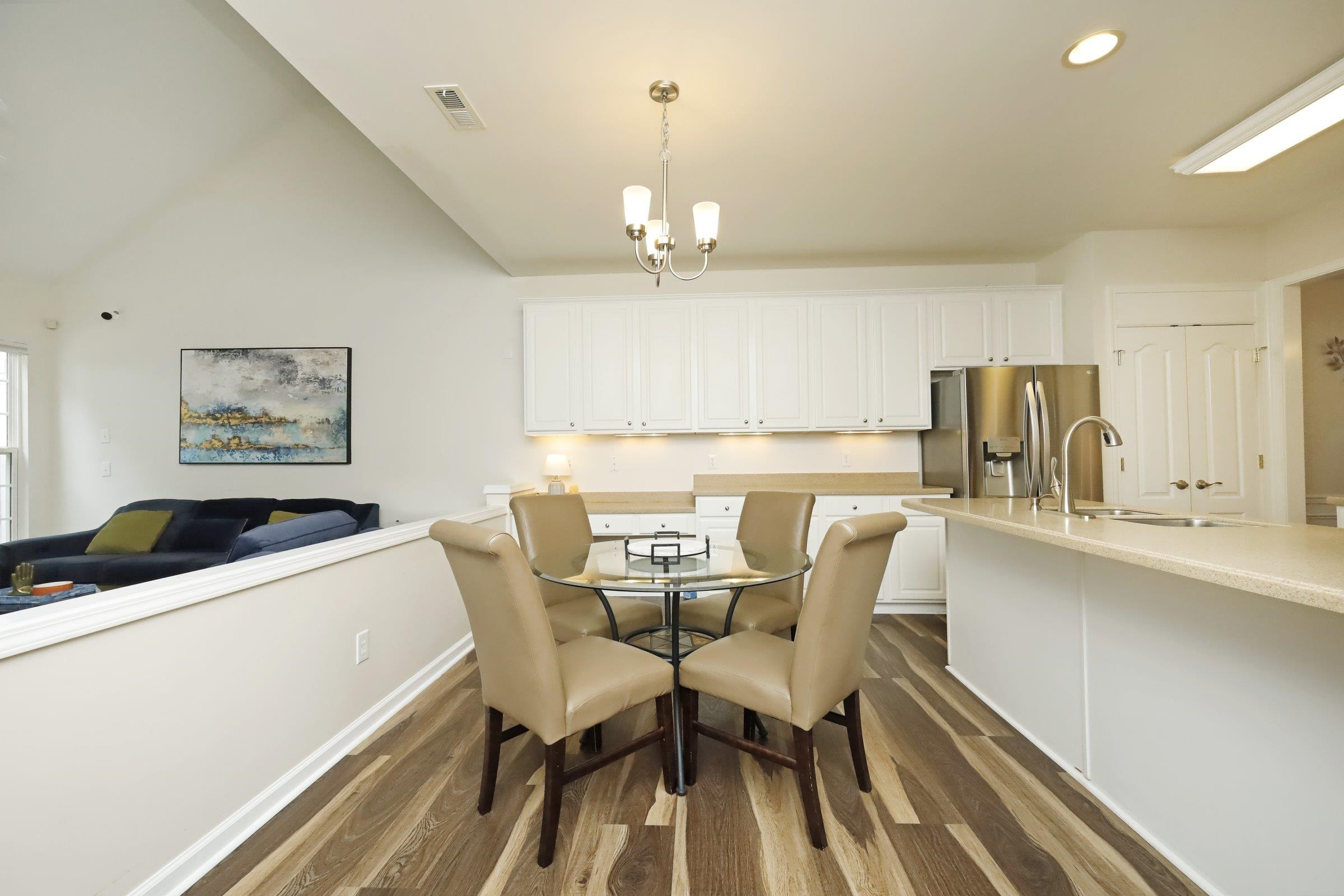 5313 Brandy Bay Road Raleigh, NC 27613 - Photo 11 of 42 a kitchen with stainless steel appliances kitchen island granite countertop a dining table chairs and a refrigerator