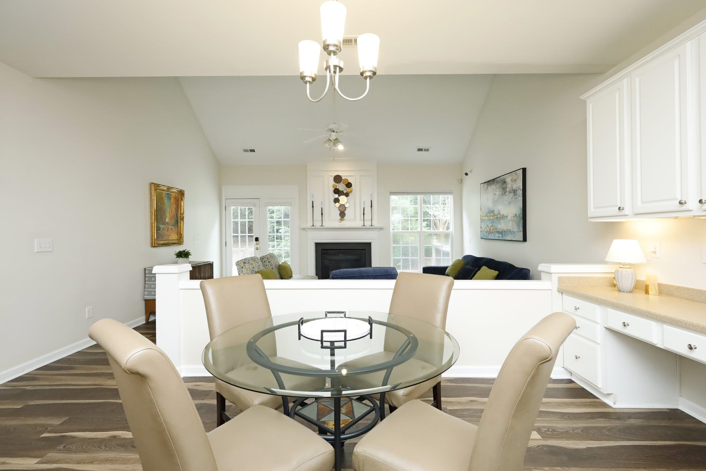 5313 Brandy Bay Road Raleigh, NC 27613 - Photo 12 of 42 a living room with furniture a fireplace and a chandelier