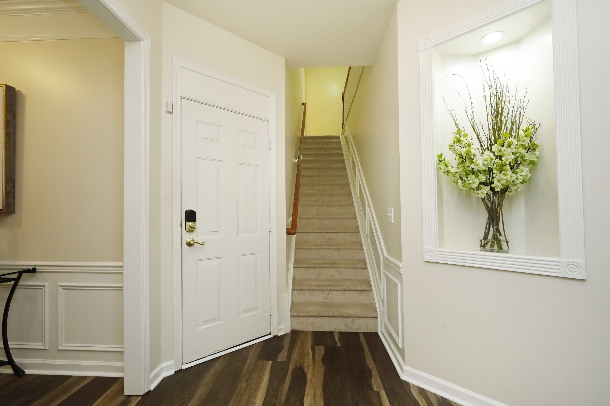 5313 Brandy Bay Road Raleigh, NC 27613 - Photo 19 of 42 a view of a hallway with wooden floor and staircase