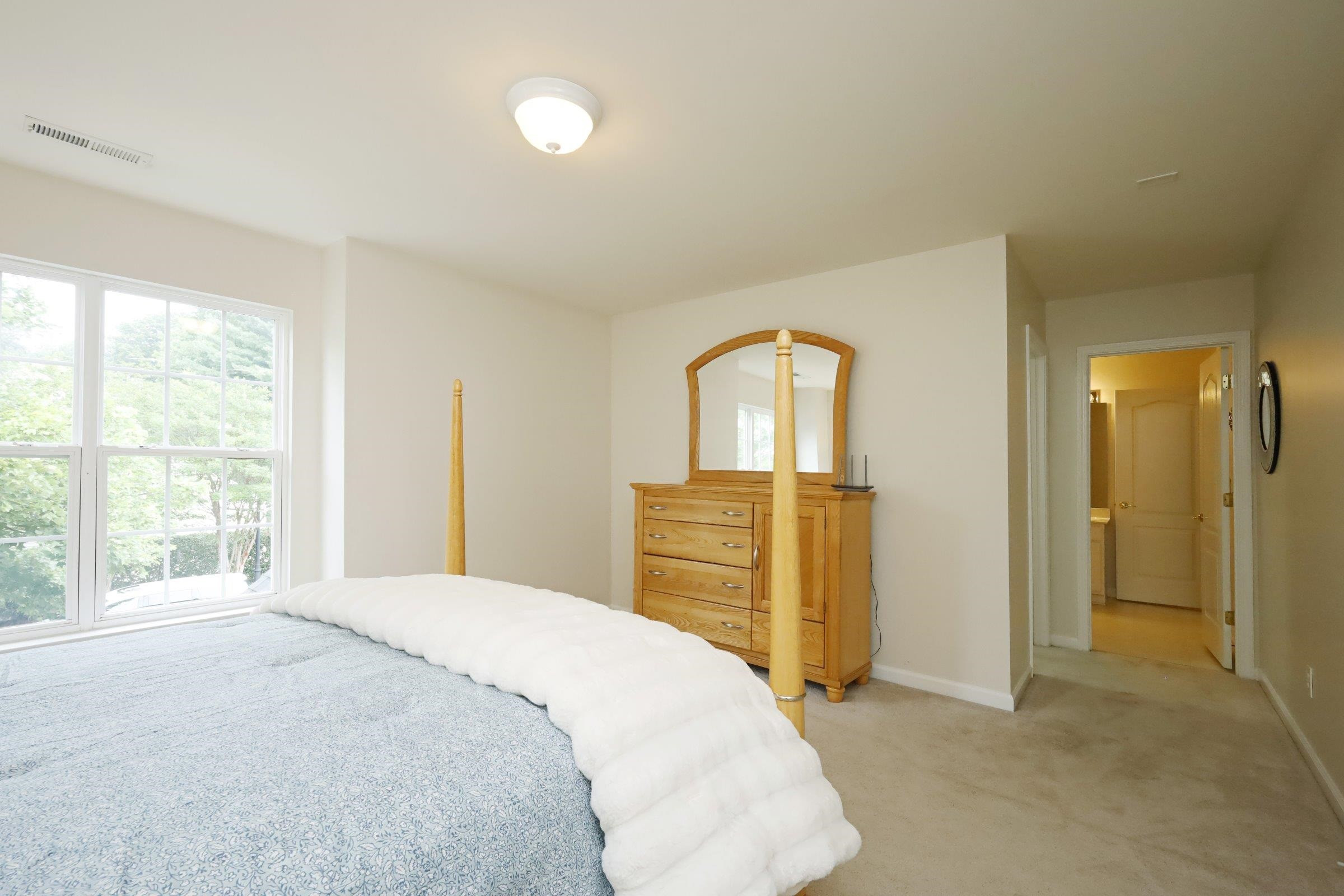 5313 Brandy Bay Road Raleigh, NC 27613 - Photo 34 of 42 a bedroom with a bed and dresser with mirror