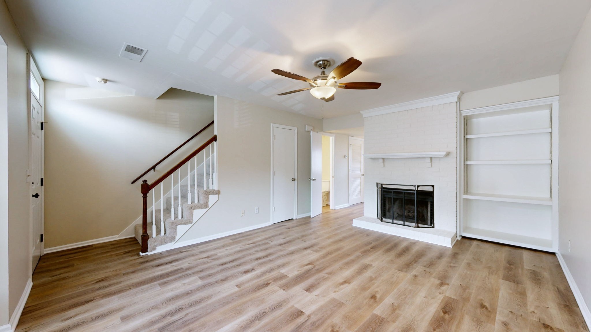 250 Sanders Ferry Road, Unit 34 Hendersonville, TN 37075 - Photo 4 of 21 a view of a livingroom with a fireplace a ceiling fan and wooden floor