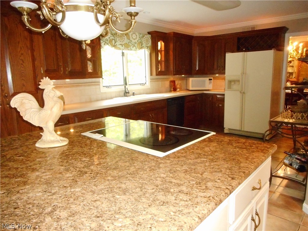 13851 Watt Road Novelty, OH 44072 - Photo 6 of 28 This kitchen was expanded and a center island added. A pantry to envy and cabinets galore are also here! Beautiful views from the kitchen window to enjoy the yard and pool!