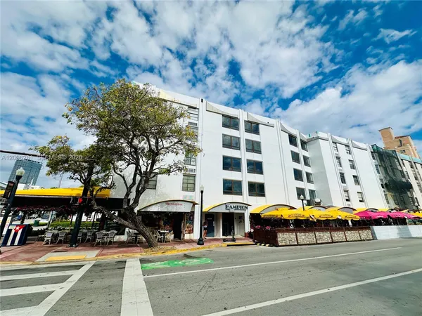 a front view of building with cars parked