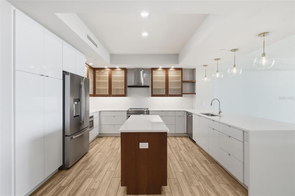 800 Collany Road, Unit 302 St. Petersburg, FL 33715 - Photo 17 of 66 a kitchen with a refrigerator and a sink