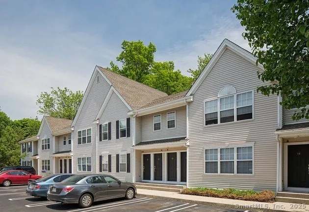 a couple of cars parked in front of a house