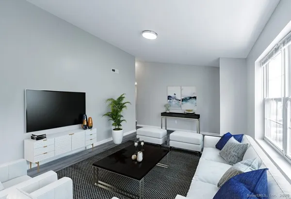 a living room with furniture and a flat screen tv